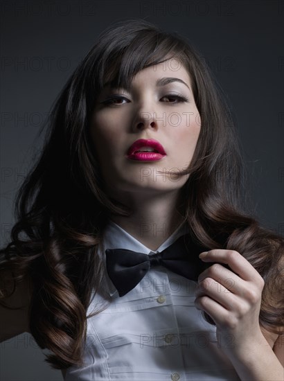 Mixed Race woman wearing bowtie