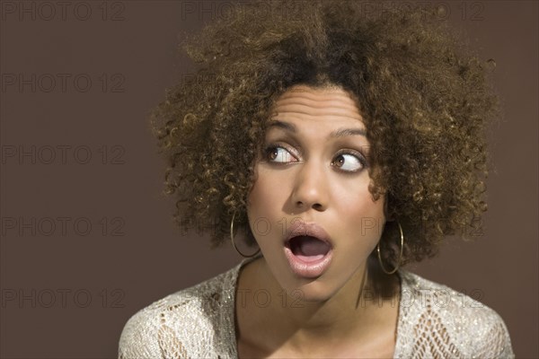 Mixed Race woman looking surprised