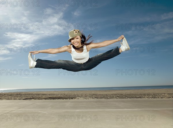 Asian woman jumping in air