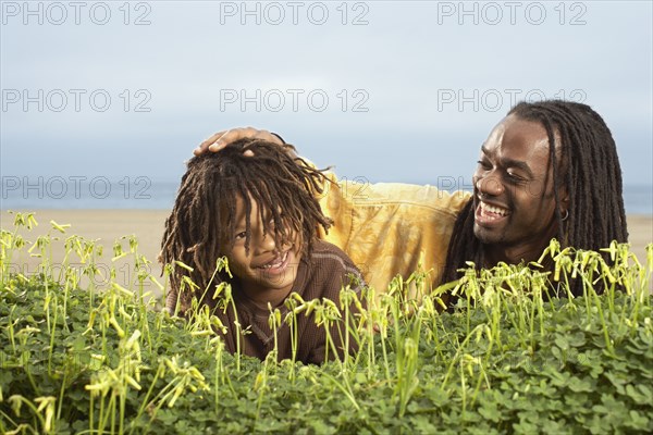 African father patting son's head