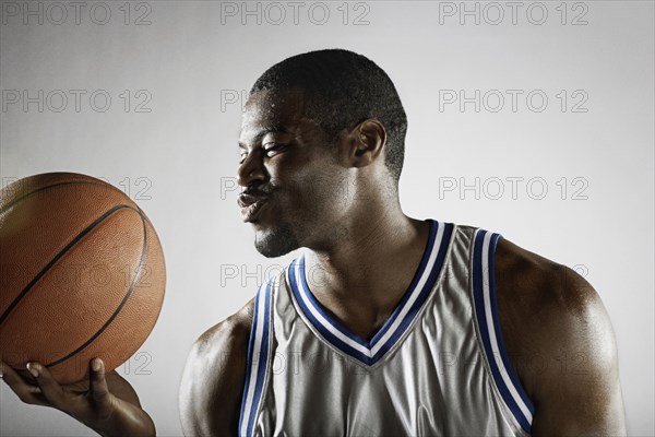 African basketball player holding basketball