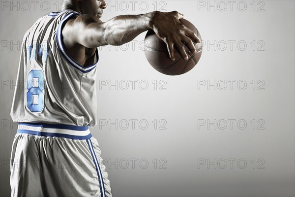 African basketball player holding basketball