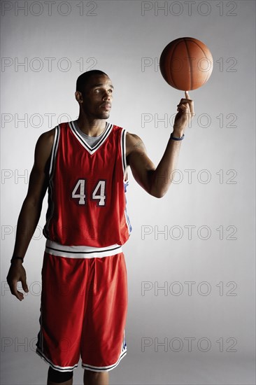 African basketball player spinning basketball