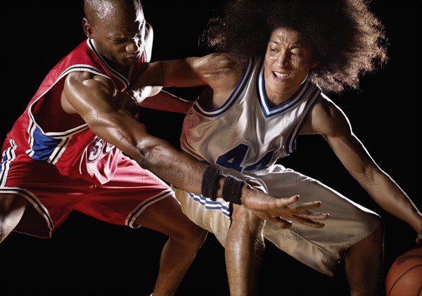 Multi-ethnic basketball players competing for basketball