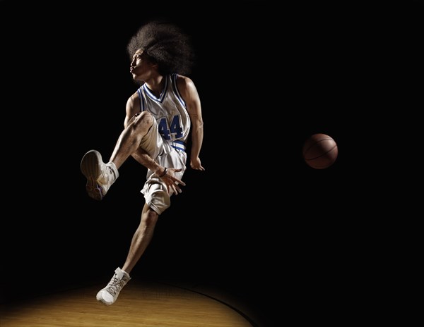 Mixed race basketball player passing basketball