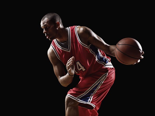 African basketball player holding basketball