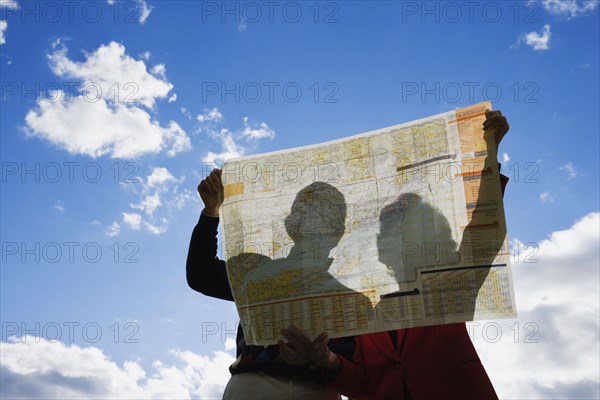 Couple looking at map outdoors