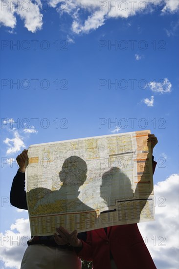 Couple looking at map outdoors