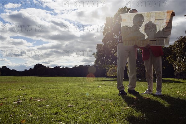 Couple looking at map outdoors