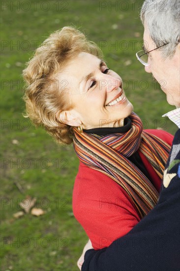 Senior couple smiling at each other outdoors