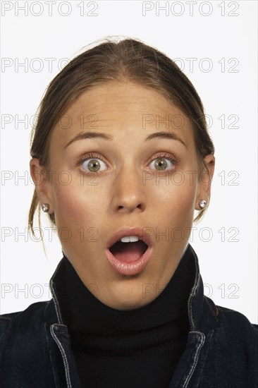 Close up studio shot of woman looking surprised