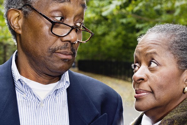 Close up of senior African couple looking at each other outdoors