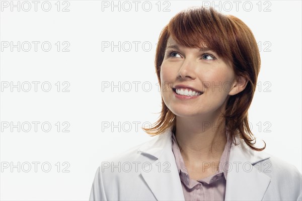 Studio shot of woman smiling and looking up