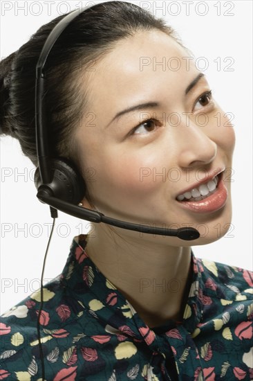 Studio shot of Asian woman wearing headset