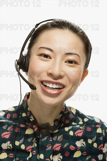 Studio shot of Asian woman wearing headset