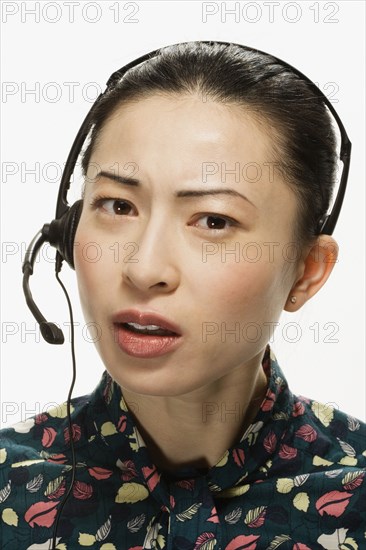 Studio shot of Asian woman wearing headset