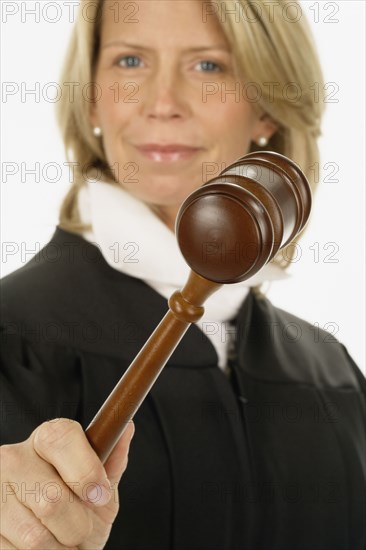 Studio shot of female judge holding gavel