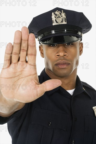 Studio shot of African male police officer