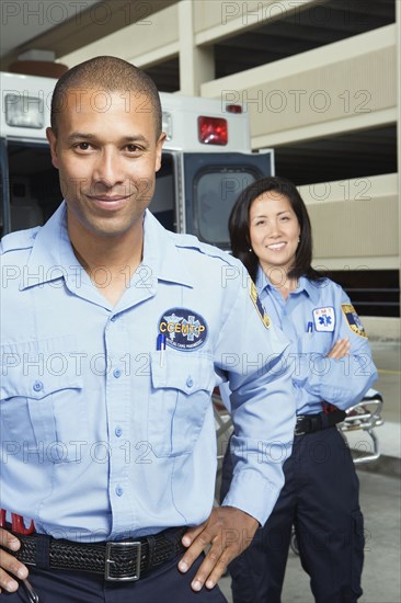 African male paramedic with co-worker in background