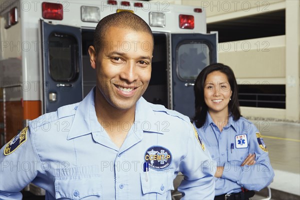 Portrait of paramedics in front of ambulance