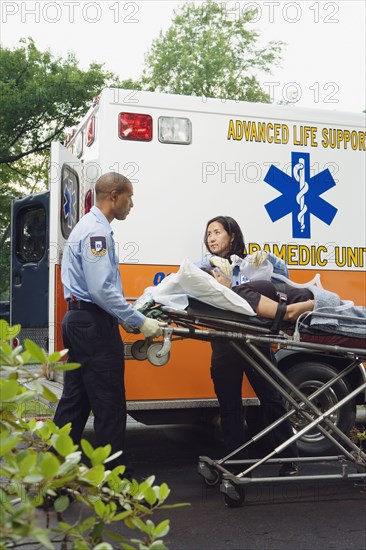 Paramedics putting woman into ambulance