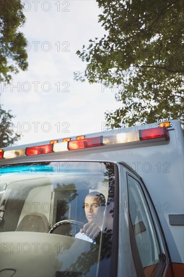 African male paramedic driving ambulance