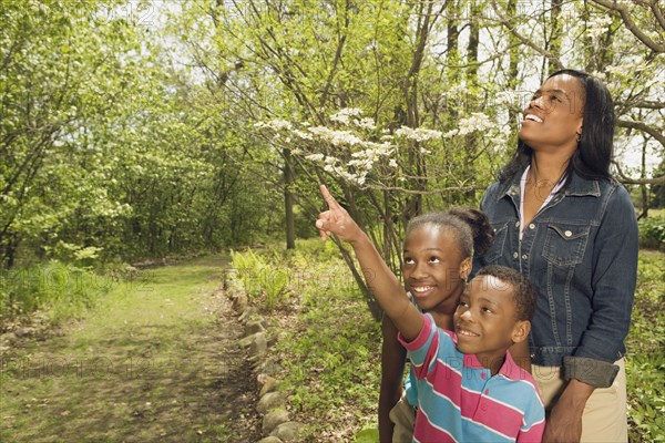 African mother and children exploring in park