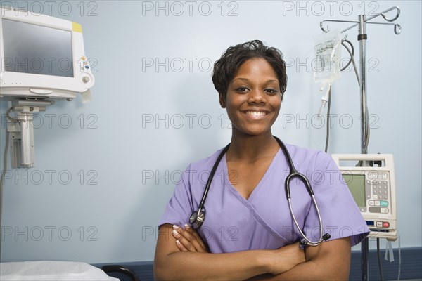 African female nurse smiling in hospital room