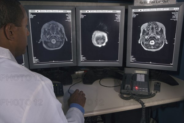 Rear view of African male doctor reviewing at brain scans