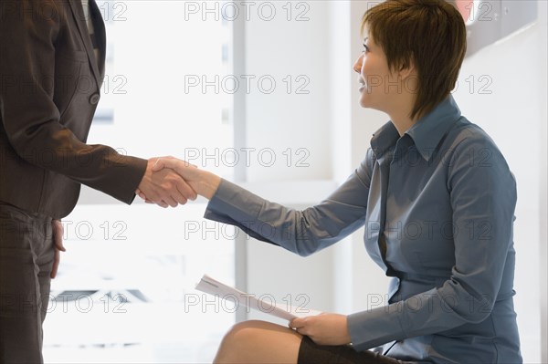 Asian businesswoman shaking hands