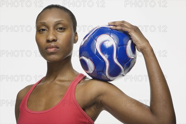 African American woman holding soccer ball