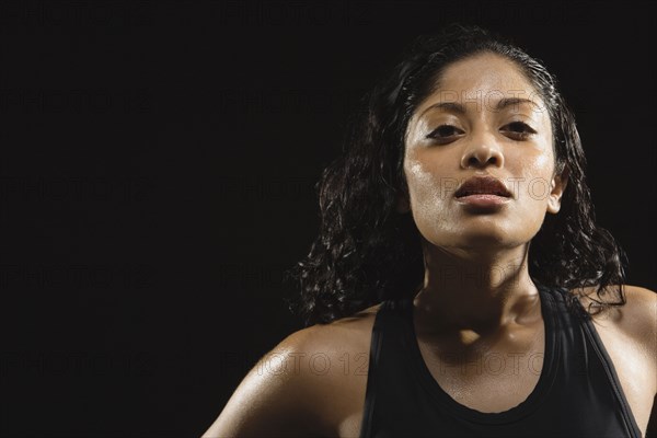 Sweaty Indian woman wearing tank top