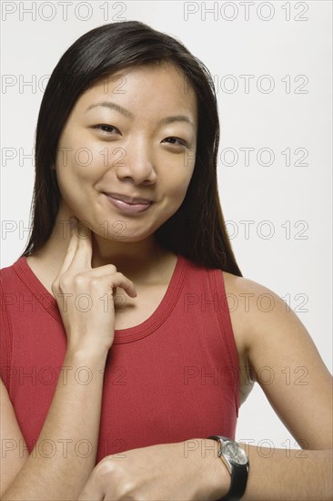 Asian woman taking own pulse
