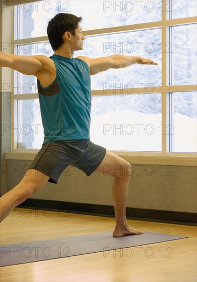 Asian man practicing yoga