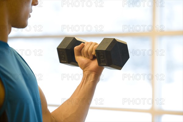 Asian man lifting weights