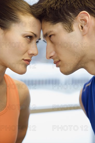 Multi-ethnic couple touching foreheads