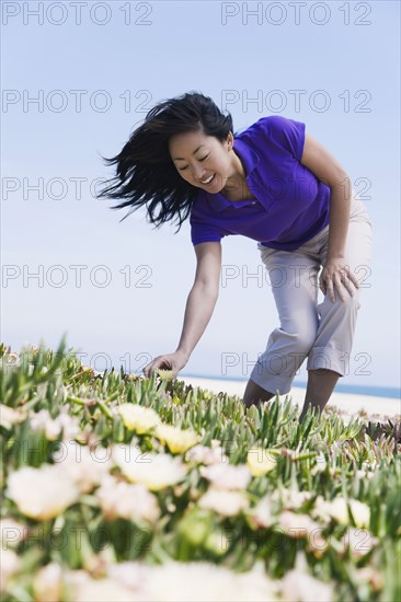 Asian woman picking flower