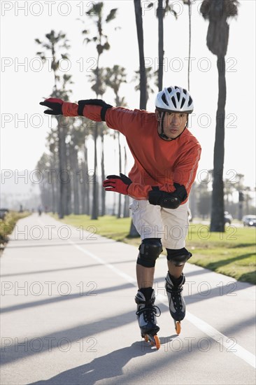 Asian man rollerblading