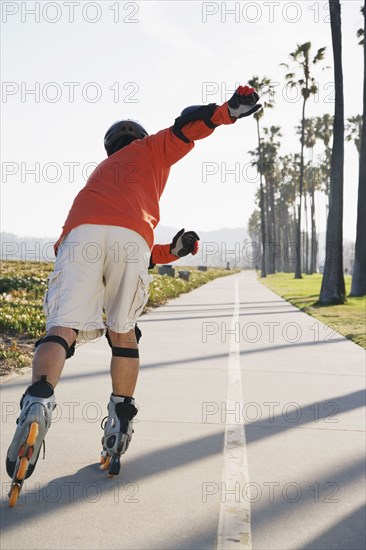 Asian man rollerblading