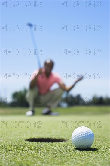 Frustrated African man on golf course
