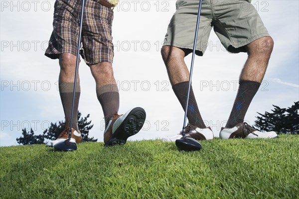 Multi-ethnic men on golf course