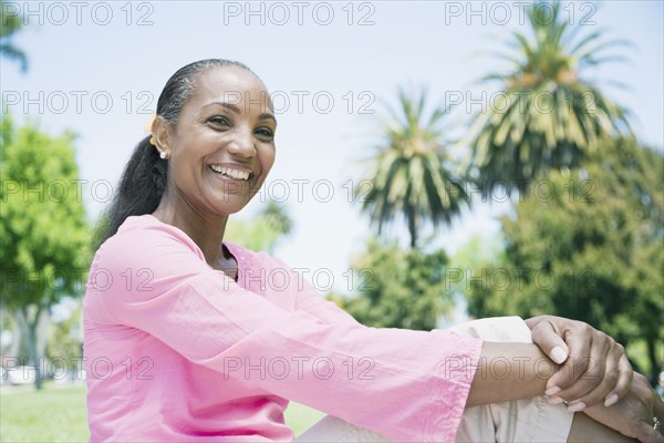 Mixed Race woman sitting outdoors
