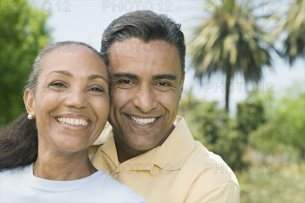 Multi-ethnic couple hugging