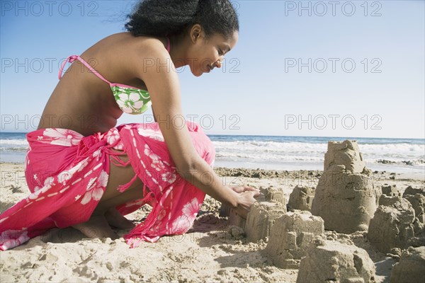 African woman building sand castles