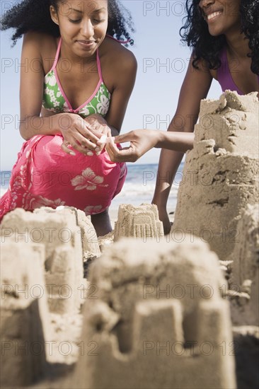 African women building sand castles