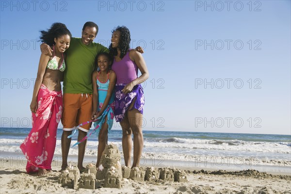 African family next to sand castle