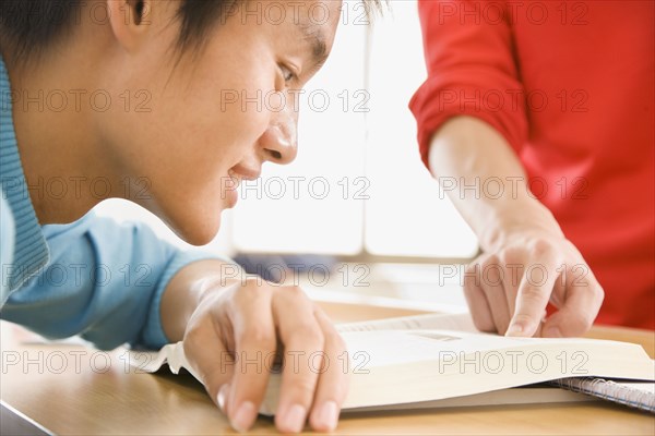 Chinese students looking at book
