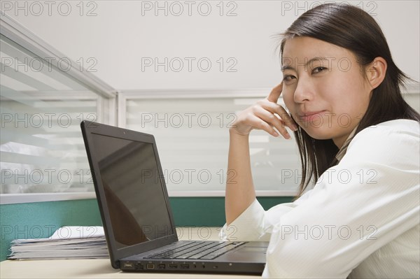 Chinese businesswoman using laptop at desk