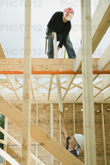 Construction workers building house