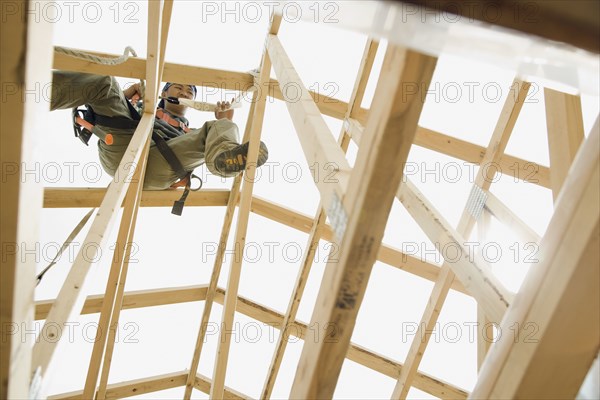 Hispanic construction worker building house